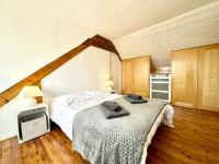 a bedroom with a bed with towels on it at Maison de pêcheur - À 200m de la plage in Ploemeur