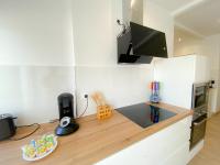 a kitchen with a wooden counter top with a desk at Les Dunes 1 in Sangatte