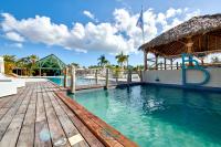 a pool at the resort with a wooden deck at Village Kawann - Toumalacai 246 in Grand-Bourg