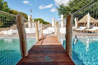 a wooden walkway leading to a swimming pool at Village Kawann - Toumalacai 246 in Grand-Bourg