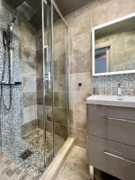 a bathroom with a shower and a sink at Hotel La Calanque in Mandelieu-La Napoule