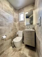 a bathroom with a toilet and a sink at Hotel La Calanque in Mandelieu-La Napoule