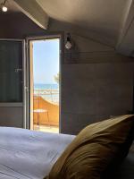 a bedroom with a bed and a view of the ocean at Hotel La Calanque in Mandelieu-La Napoule