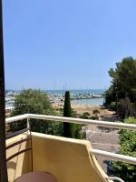 a balcony with a view of a beach and the ocean at Hotel La Calanque in Mandelieu-La Napoule