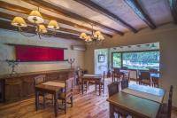 a dining room with wooden tables and chairs at Lares De Chacras in Chacras de Coria