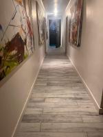 a long hallway with paintings on the walls at la Romana Luxe et sérénité au cœur de Saint-Tropez Suites spacieuses avec jardin enchanteur in Saint-Tropez