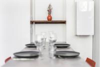 a table with plates and wine glasses on it at Gambetta 304 CahorsCityStay in Cahors