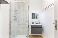 a white bathroom with a shower and a sink at Gambetta 304 CahorsCityStay in Cahors