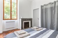 a bedroom with a bed with two towels on it at Gambetta 304 CahorsCityStay in Cahors