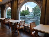 a room with tables and chairs and a large window at Estalagem Santa Iria Hotel & Spa in Tomar
