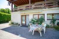 a table and chairs in front of a house at Les cerisiers un petit coin de paradis pour deux proche du lac! in Sévrier