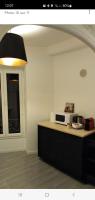 a kitchen with a counter top with a microwave at Baieta Chambre rouge in Moulinet