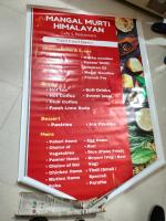 a sign for a menu at a restaurant at MangalMurti Himalyan Hotel in Almora