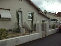 a white fence in front of a house at ADOUR FETES ET PLAISIRS in Aureilhan