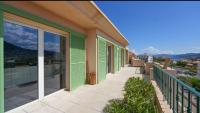 a balcony of a house with a view of the mountains at Chez Pasqua ! Appartement spacieux avec terrasse 2 chambres 6 couchages en Rooftop in LʼÎle-Rousse