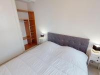 a bedroom with a white bed and two night stands at Appartement Menton, 2 pièces, 4 personnes - FR-1-196-336 in Menton