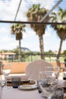 a table with two wine glasses on top of it at Hotel Alicante Golf in Alicante
