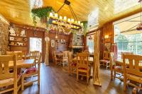 a dining room with wooden floors and tables and chairs at Apartaments La Neu in Ordino