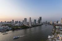 a river with a city in the background at Chatrium Hotel Riverside Bangkok in Bangkok