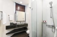 a bathroom with a sink and a toilet and a mirror at Chatrium Hotel Riverside Bangkok in Bangkok