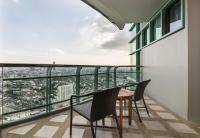a balcony with two chairs and a table at Chatrium Hotel Riverside Bangkok in Bangkok