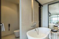 a bathroom with a bath tub and a toilet at Chatrium Hotel Riverside Bangkok in Bangkok
