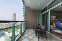 a balcony with a view of a city at Chatrium Hotel Riverside Bangkok in Bangkok