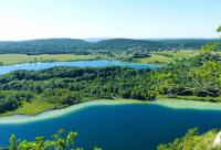 an aerial view of a large blue lake at Studio B hyper centre in Lons-le-Saunier
