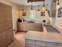 a kitchen with wooden cabinets and a counter top at Grande Villa à Sainte Maxime - Golfe de Saint Tropez in Sainte-Maxime