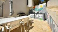 a kitchen with white counter tops and a stove at Séjour de Luxe à Golfe Juan, 15 mn de Cannes in Vallauris