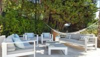 a group of white lounge chairs and a hammock at Séjour de Luxe à Golfe Juan, 15 mn de Cannes in Vallauris