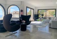 a living room with a chair and a couch at Séjour de Luxe à Golfe Juan, 15 mn de Cannes in Vallauris