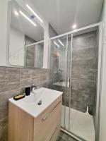 a bathroom with a white sink and a shower at Saint-Raphaël-Front de Mer-WIFI-CLIM in Saint-Raphaël