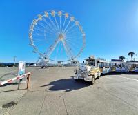 a large ferris wheel in a parking lot at Saint-Raphaël-Front de Mer-WIFI-CLIM in Saint-Raphaël