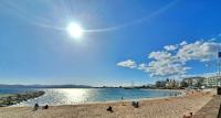 a group of people on a beach near the water at Saint-Raphaël-Front de Mer-WIFI-CLIM in Saint-Raphaël