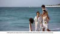 a group of three people standing on the beach at Jumeirah Mina Al Salam Dubai in Dubai