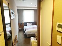 a small room with a bed and a window at HOTEL SUI AKASAKA by ABEST in Tokyo