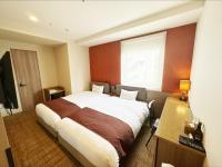 a bedroom with a bed and a desk and a window at HOTEL SUI AKASAKA by ABEST in Tokyo
