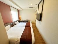 a hotel room with two beds and a flat screen tv at HOTEL SUI AKASAKA by ABEST in Tokyo