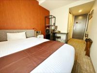 a hotel room with a large bed and a door at HOTEL SUI AKASAKA by ABEST in Tokyo