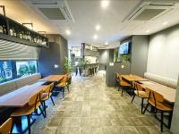 a dining room with wooden tables and chairs at HOTEL SUI AKASAKA by ABEST in Tokyo