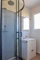 a bathroom with a glass shower and a sink at Jolie maison pour 8 personnes in Plobannalec-Lesconil