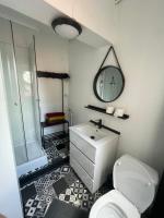 a bathroom with a sink and a toilet and a mirror at La clef Sithieu in Saint-Omer