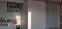 a kitchen with a door open to a kitchen with white cabinets at Mas Vincent in La Fare-les-Oliviers