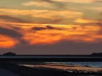 a sunset on the beach with a cloudy sky at Sur le chemin de la plage in Cherbourg en Cotentin