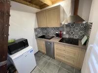 a kitchen with a sink and a stove at La cabane de dany in La Bresse