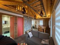 a living room with a couch and a table at La cabane de dany in La Bresse