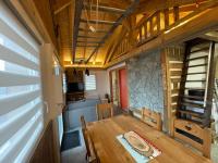 a dining room with a wooden table in a house at La cabane de dany in La Bresse