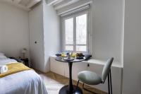 a bedroom with a table and a bed and a window at New and Designed Studio well Equipped - Heart of Paris 2 in Paris