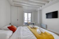 a white bedroom with a bed with towels on it at New and Designed Studio well Equipped - Heart of Paris 2 in Paris